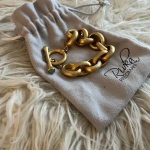 Rivka Friedman Matte Gold Rolo Link Toggle Bracelet with Blue Stones.